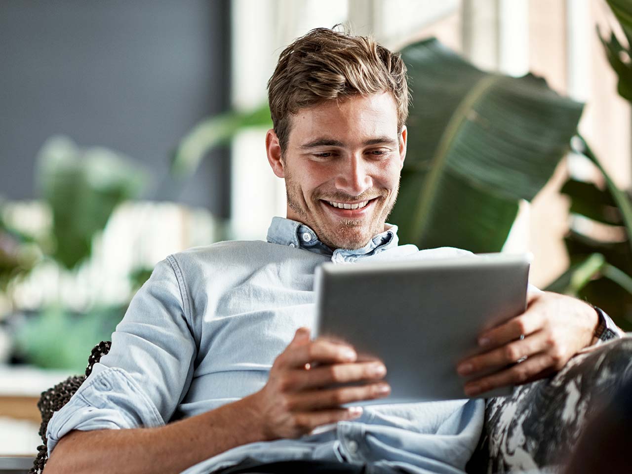 Man smiling looking at an iPad